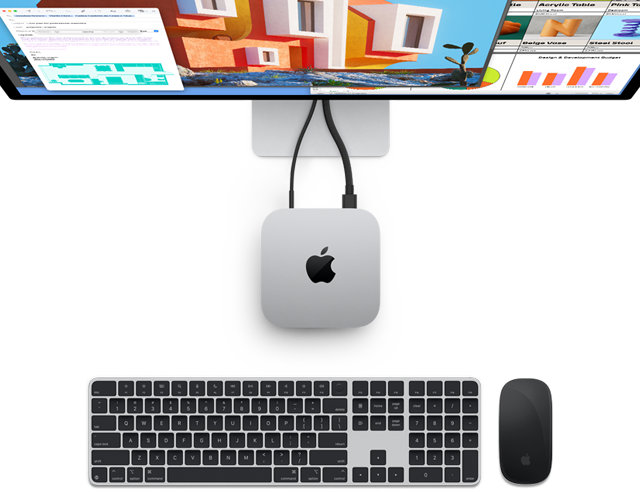 Un Mac mini color argento ripreso dall’alto, su cui si nota il logo Apple; è collegato a un monitor e accanto ci sono una tastiera Magic Keyboard e un Magic Mouse